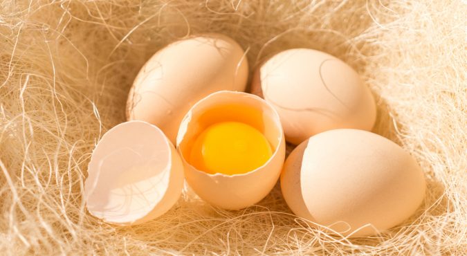 Fresh chicken eggs on the background of natural hay. Organic Food