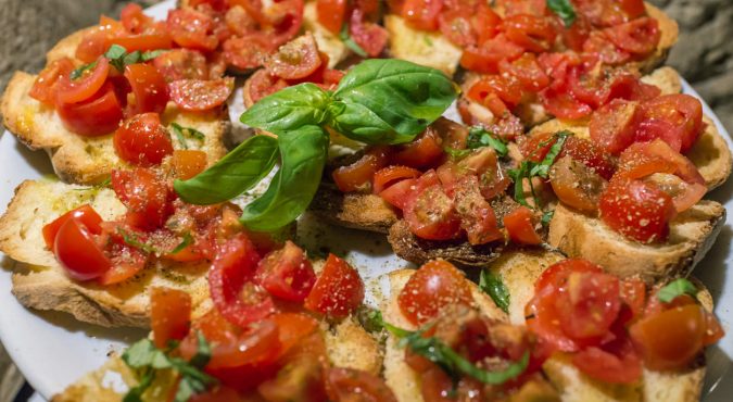 Italian bruschettas with chopped tomato and basil ready for breakfast